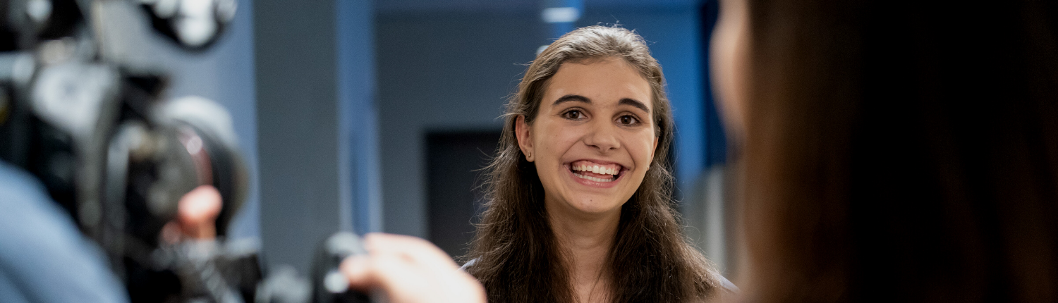 Girl smiling for video camera interview